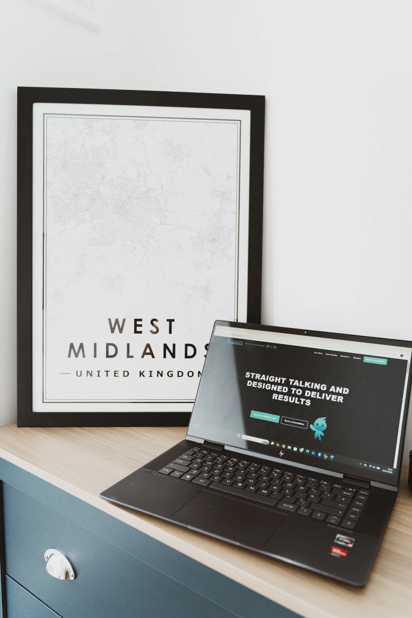 Laptop displaying a client website beside a West Midlands map, representing Digital Sizzle's regional focus